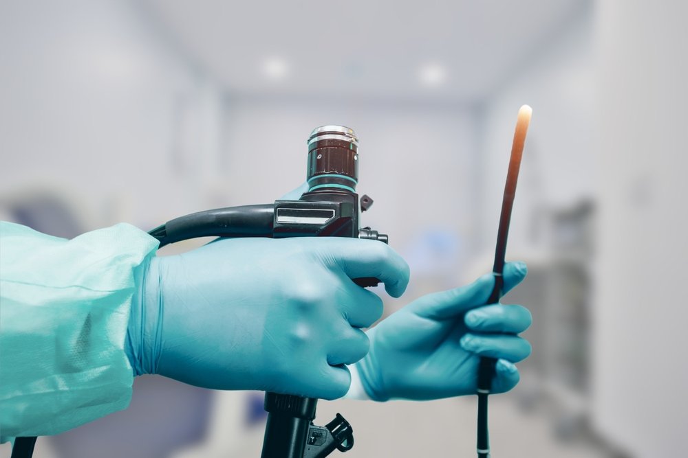 The,Image,Shows,A,Medical,Professional,Wearing,Gloves,,Holding,An